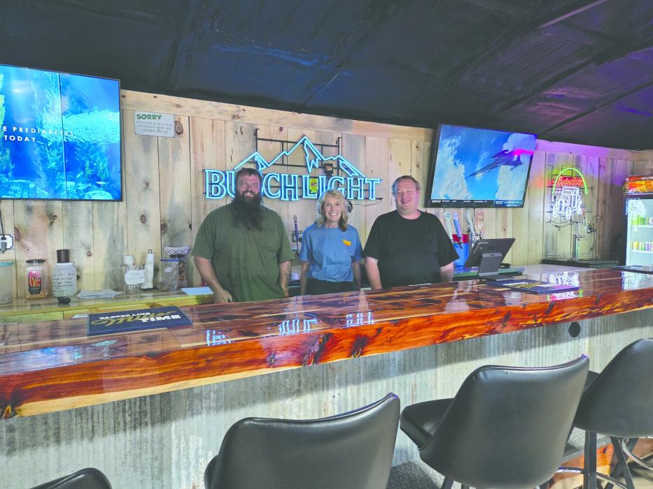 From left: Brian Irwin, Traci McDonald, and Brian Oedekoven gather behind the handcrafted bar top—built with local pride and hometown materials. Photos by Shannon Jost • timesleader1@gmail.com