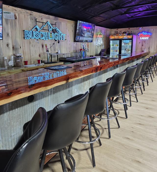 The new addition at Ollie’s Out Back offers a warm, family-friendly space to unwind, complete with cozy seating, arcade games, and a handcrafted bar that blends hometown charm with modern flair.