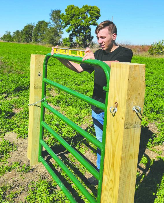 Keenan is seen here leveling a gate for his archery range project for the Tri-State Youth Association. Submitted photo