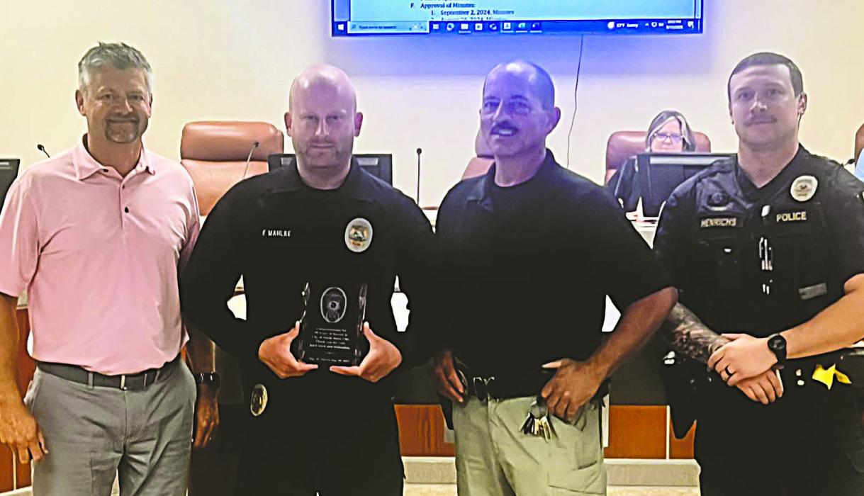 Officer Faustin Mahlke is honored by city officials and fellow officers on Sept. 16 for 10 years of service with the North Sioux City Police Department, recognizing his dedication to public safety, community outreach, and emergency response. From left: Mayor Chris Bogenrief, Officer Faustin Mahlke, Police Chief Richard Headid, and Sergeant Jesse Henrichs.  Submitted photo
