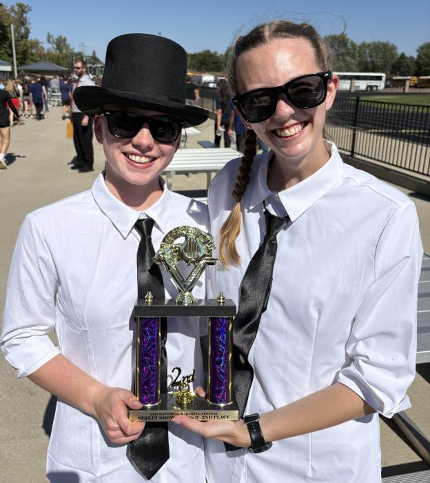 Drum Major Mia Riibe and Guard Captain Danica Euliss accepting the 2nd place trophy. Submitted photo