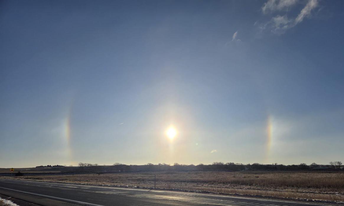 A pair of rainbow‑hued sundogs flank the sun over a rural road near Elk Point, S.D., on Dec. 29, 2025. The colorful optical display, caused by sunlight refracting through ice crystals in the upper atmosphere, is known as a parhelion. Sundogs often appear on cold, clear mornings when the sun is low on the horizon. Photo by Shannon Jost • timesleader1@gmail.com