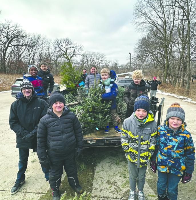 Scouts from Troop and Pack 28 gather Christmas trees across Dakota Dunes on Jan. 3. The trees were delivered to the Dorothy Pecaut Nature Center, where they will be chipped into mulch for use along the park’s hiking trails this spring.