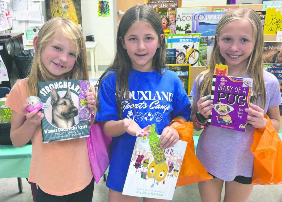 On March 19th, Panther elementary students could cash in sticker winnings from Storyland Carnival games for books, bookmarks and other prizes. From left : Kiera Clifford, Malloreigh McClung, and Dakota Pearman. Submitted photo