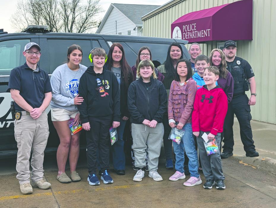 Huskies in the Structured Learning Center (SLC) classroom, at Elk Point-Jefferson, visited the local police station on Wednesday, April 15, 2026. Front from left: Police Chief Limoges, Kayla Sharkey, Kyle Dudley, Shawn McNaughton-Miller, Yixian Norby, and Nathan Rogers. Middle row from left: Cassandra Schmith, Clara Lambing, Iggy Garscia, and Lucas McMahan. Back row from left: Alyssa Brown, Brandy Moore, and Officer Mach. Photo by Kelly Riibe • times2reporter@gmail.com