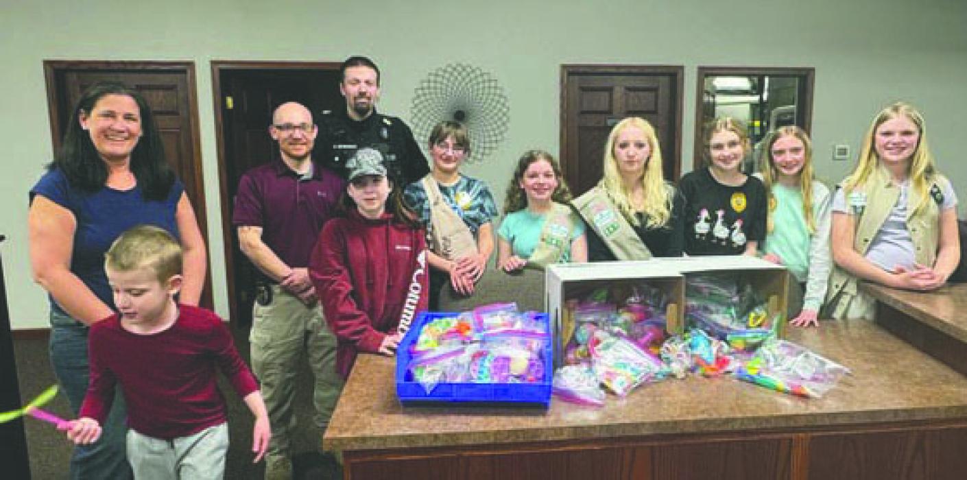 From left: Kelli Kappenman, Thomas Kappenman, Police Chief Jacob Limoges, Officer Austin Edwards and members of Girl Scout Troop 161 are pictured as the troop delivers the sensory bags they assembled for the Elk Point Police Department. Submitted photo