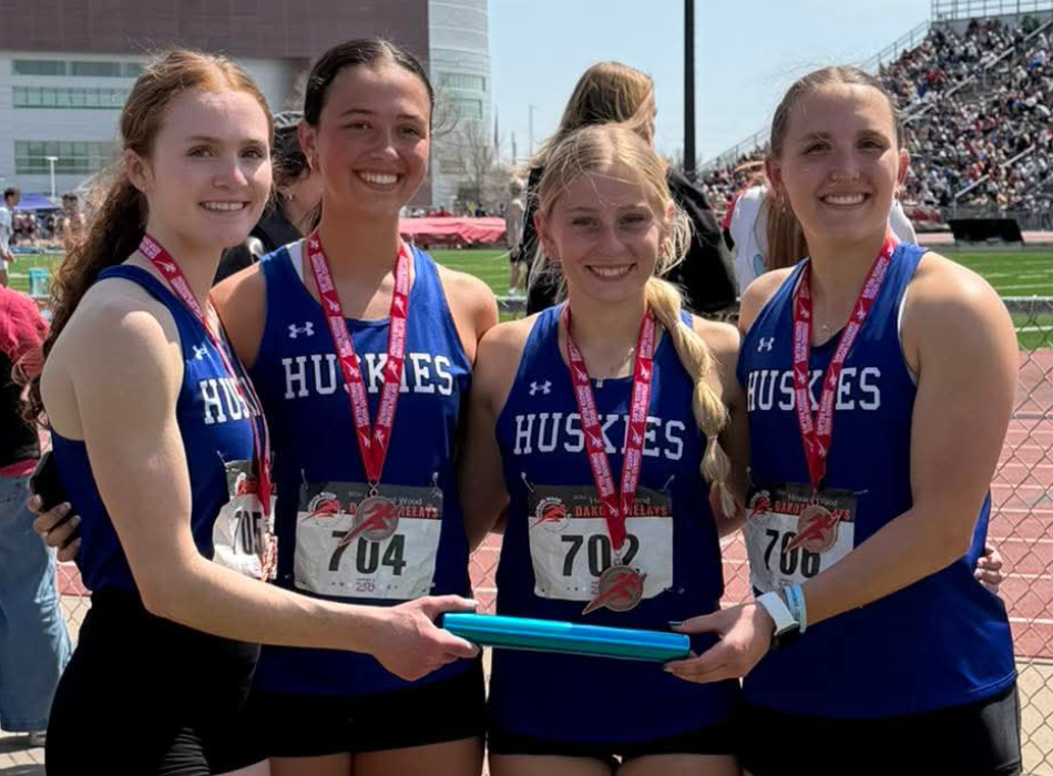 The Husky girls 4x100‑meter relay team places seventh at the Howard Wood Dakota Relays, running a season‑best 51.14 on May 1, 2026. From left: Lauren McDermott, Paige Jacobs, Makinley Hammitt and Cera Schmitz. McDermott also earned individual medals in the hurdle events. Submitted photo