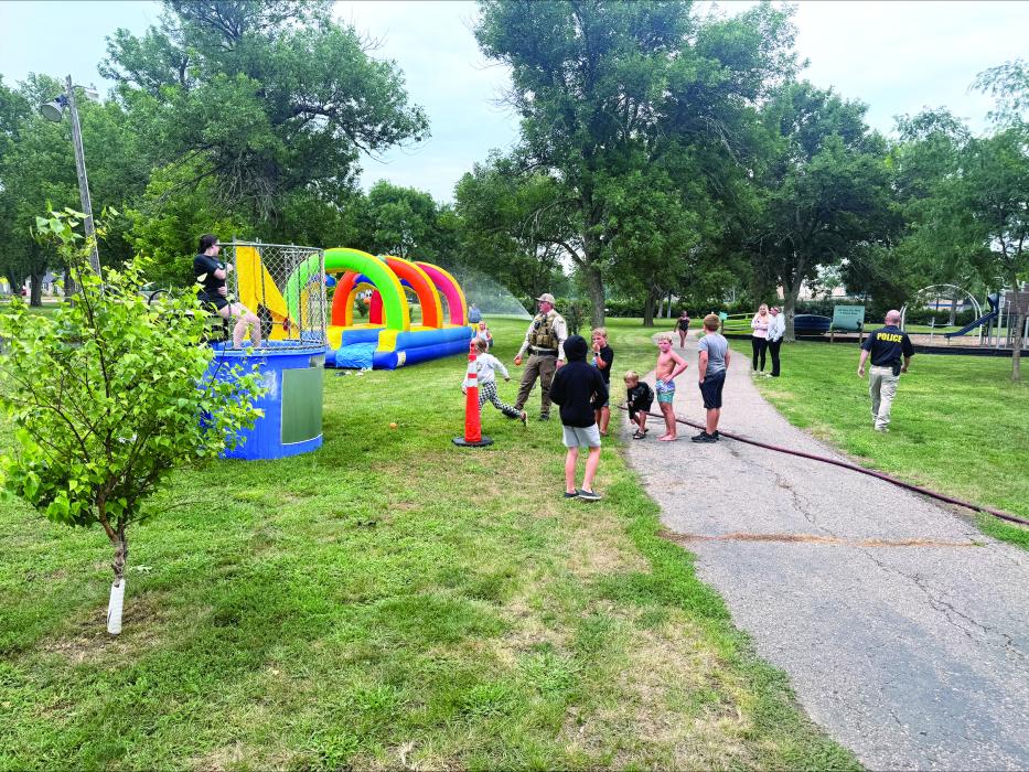 Families and neighbors gathered at Elk Point City Park on Aug. 4 for the community’s first National Night Out, an evening of food, games and police‑community engagement hosted by the Elk Point Police Department. The event featured burgers and hot dogs, a dunk tank, slip‑and‑slide, bouncy house and other activities as officers thanked residents for helping make the inaugural celebration a success. Submitted photos