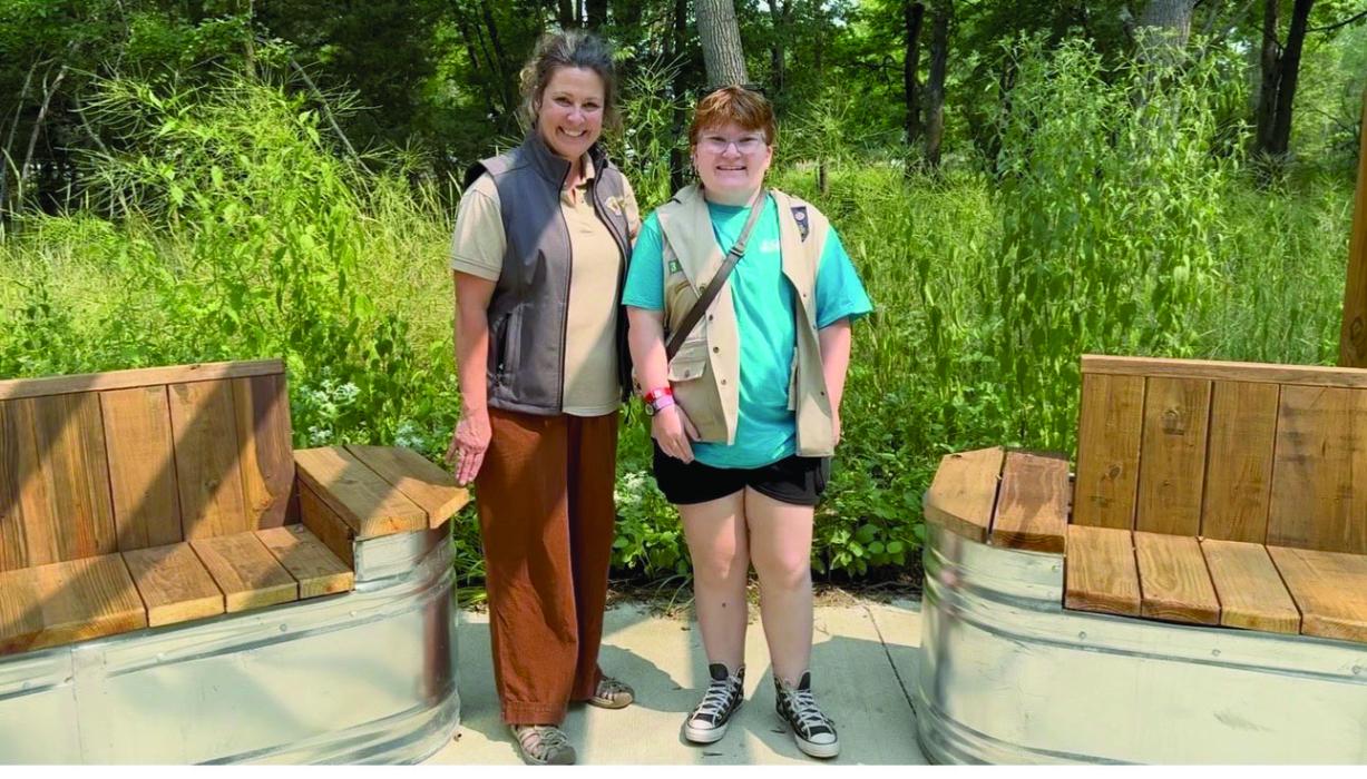 Adams Homestead and Nature Preserve park manager Jody Moats, left, stands with Megan VonHaden beside the two watertank benches VonHaden built for her Girl Scout Gold Award project. The benches were designed to give visitors a comfortable place to rest and enjoy the homestead. Submitted photo