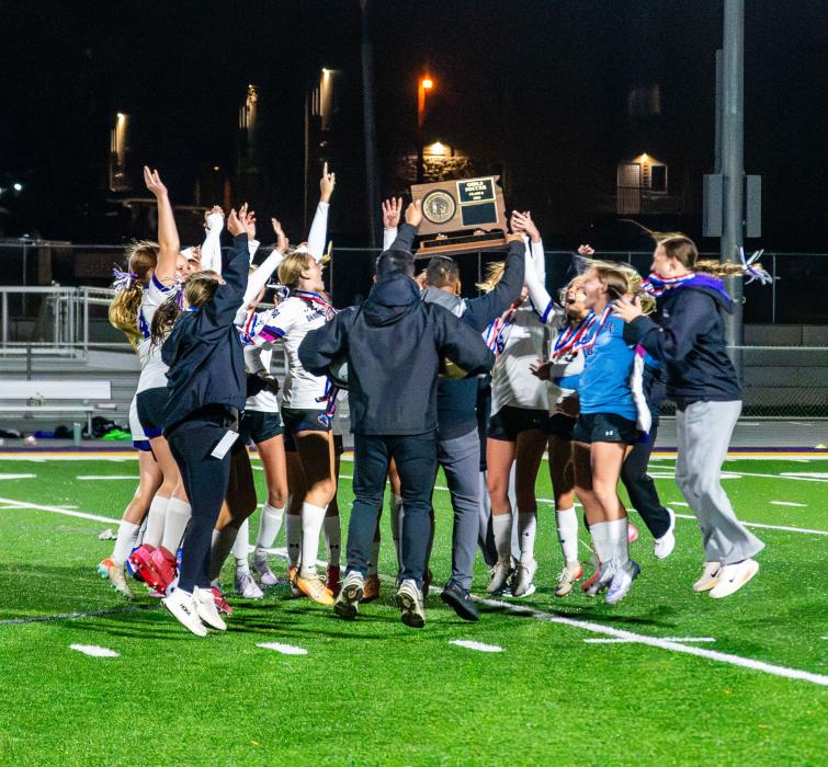 Panther head coach Jesse Castillo holds up the championship plaque as his team jumps with excitement on Saturday, October 17, 2026. Photos by Peterman Sports Photography • stevepeterman5@gmail.com