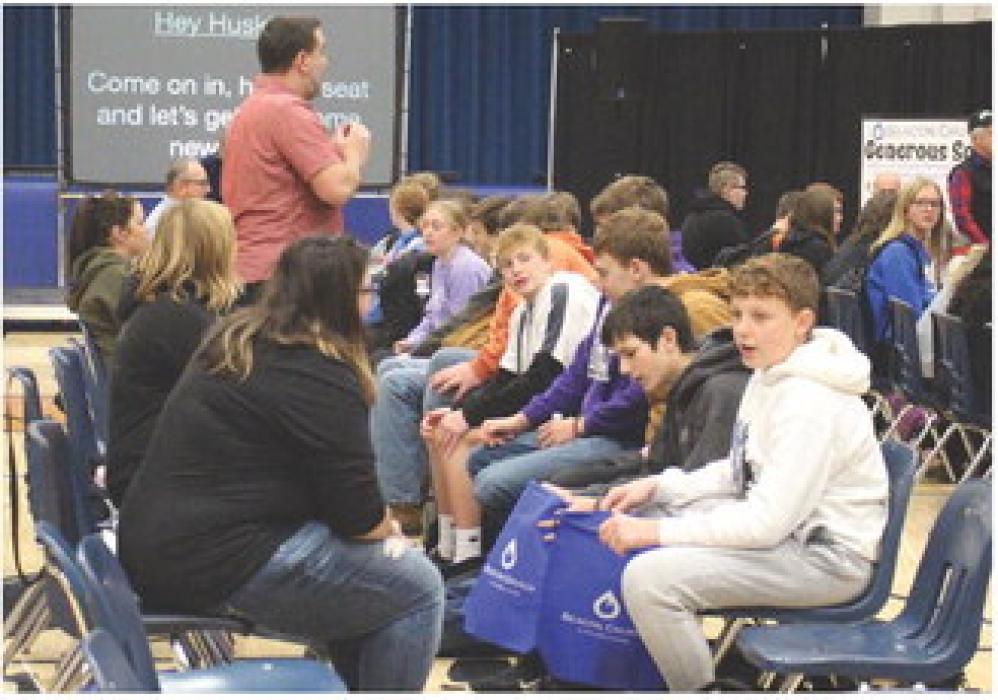 Volunteers of Beacon Church, on the left, assist EPJ students, on the right, to find their correct shoe size and make sure they fit. Students pictured, from front to back, are, Connor Sayler, Ben Prouty, Luke Schmitz, Anthony Tatro, Jackson Neal and Molly Geary. Photo by Beth Sherard-Hutcheson • times1reporter@gmail.com