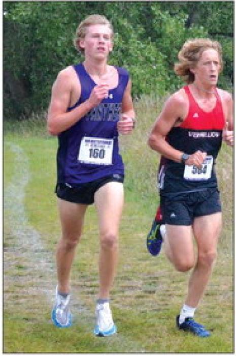 Avery Bradshaw gains on a Vermillion and West Central runner at the Beresford cross country invitational Aug. 26. He completed the course in 18:30. Photo by Kelly Riibe